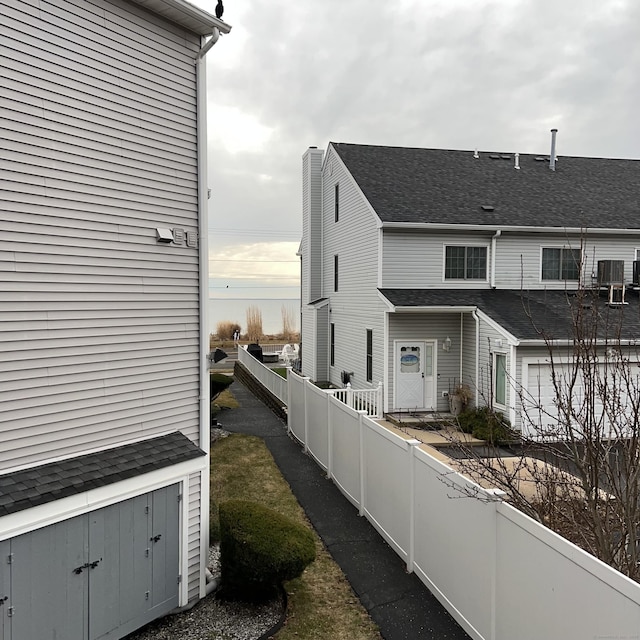 view of side of home with central air condition unit