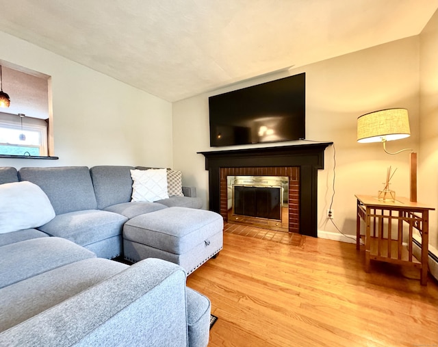 13 Lancer Dr, Enfield, CT 06082 - living room with light wood-type flooring, a fireplace, and baseboards