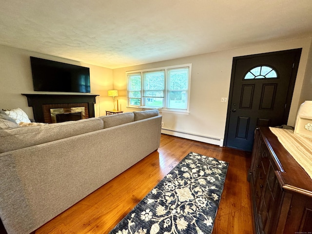 13 Lancer Dr, Enfield, CT 06082 - living area featuring a baseboard radiator, wood finished floors, and a brick fireplace