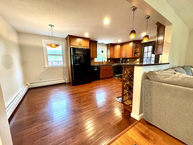 13 Lancer Dr, Enfield, CT 06082 - kitchen with black appliances, dark countertops, healthy amount of natural light, dark wood-style floors, and a textured ceiling