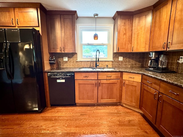 13 Lancer Dr, Enfield, CT 06082 - kitchen featuring black appliances, a sink, light wood-style flooring, brown cabinets, and a textured ceiling