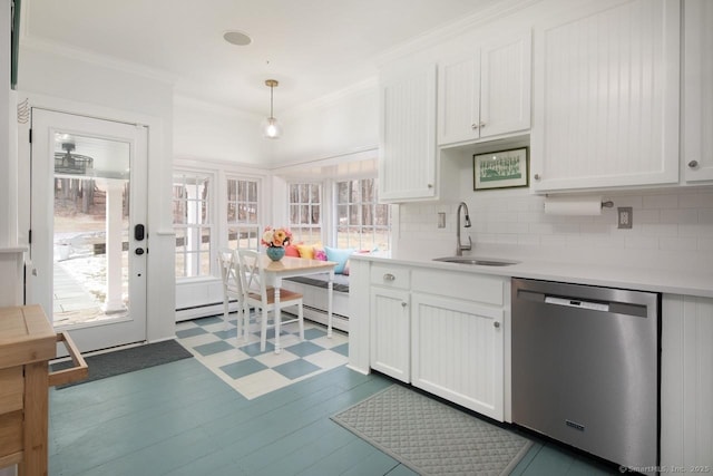 kitchen featuring decorative light fixtures, stainless steel dishwasher, white cabinetry, and sink