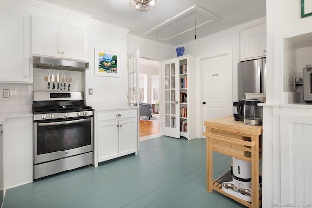 kitchen with stainless steel appliances, crown molding, and white cabinetry