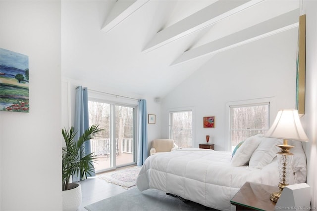 bedroom featuring access to outside, wood-type flooring, beamed ceiling, and high vaulted ceiling