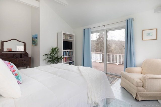 bedroom with lofted ceiling with beams and access to exterior