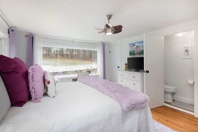 bedroom with ceiling fan, light hardwood / wood-style flooring, and ensuite bath