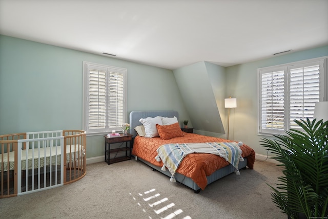 carpeted bedroom with multiple windows