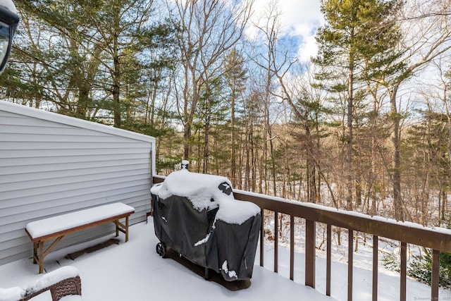 snow covered deck with a grill