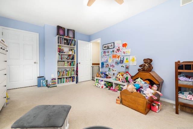 recreation room featuring light colored carpet and ceiling fan