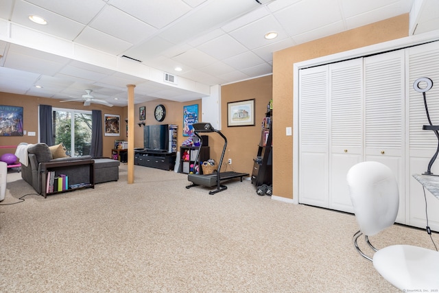 workout room featuring light colored carpet and ceiling fan