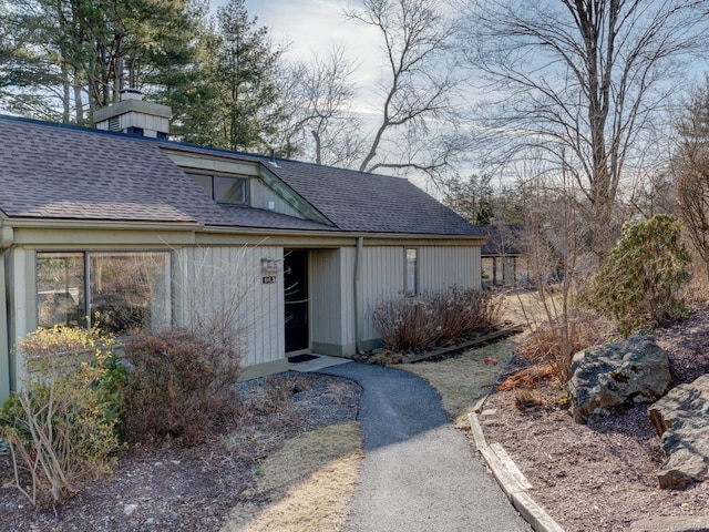 view of front of home with a shingled roof