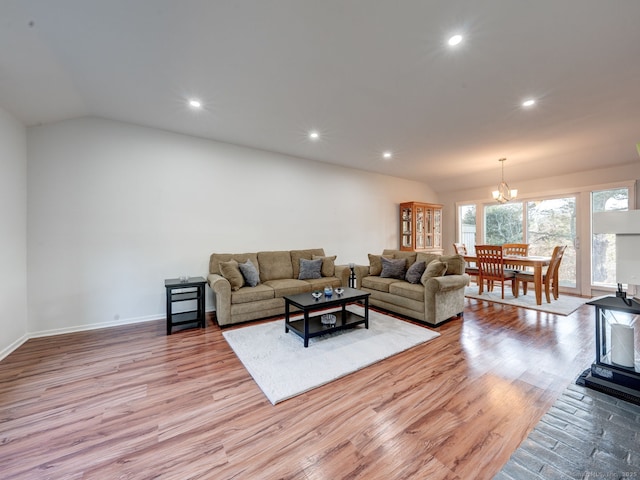 living area featuring wood finished floors, lofted ceiling, a chandelier, and recessed lighting