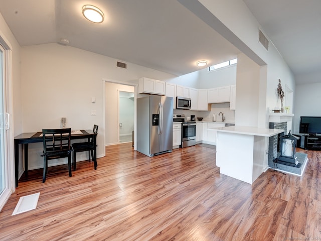 kitchen with stainless steel appliances, visible vents, and light countertops