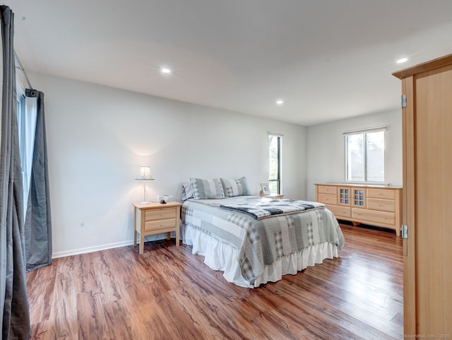 bedroom with recessed lighting, baseboards, and wood finished floors