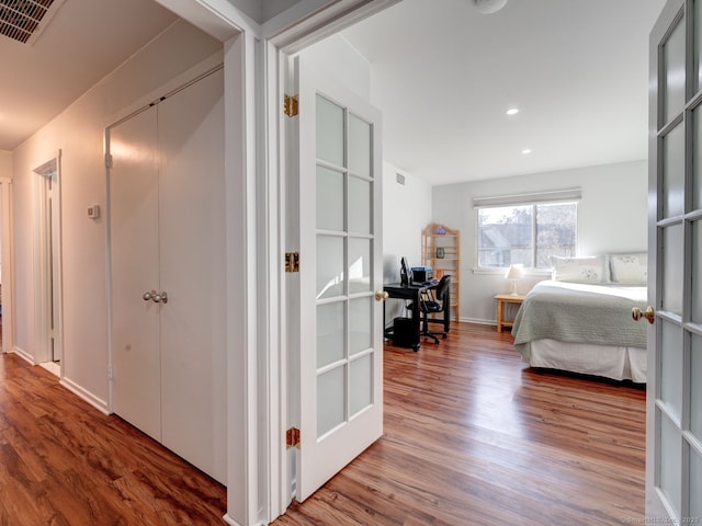 hall featuring recessed lighting, visible vents, and wood finished floors