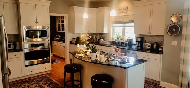 kitchen with white cabinetry, appliances with stainless steel finishes, and a center island