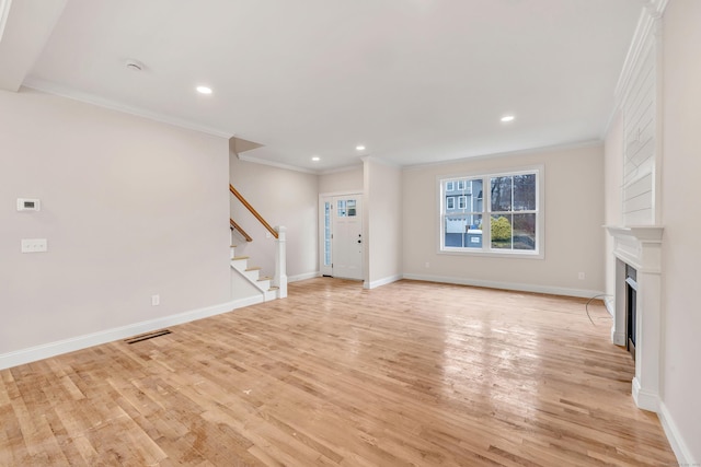 unfurnished living room with light hardwood / wood-style flooring and ornamental molding