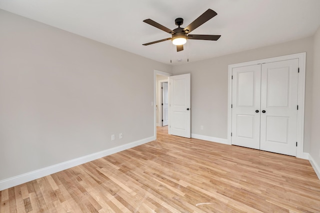 unfurnished bedroom featuring ceiling fan, light hardwood / wood-style flooring, and a closet