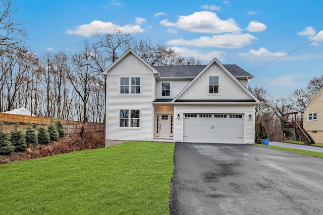 view of front of home featuring a garage and a front lawn