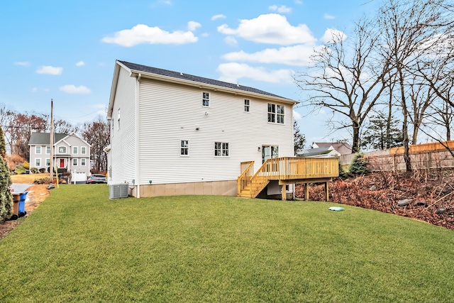 back of house featuring a wooden deck, central AC unit, and a lawn