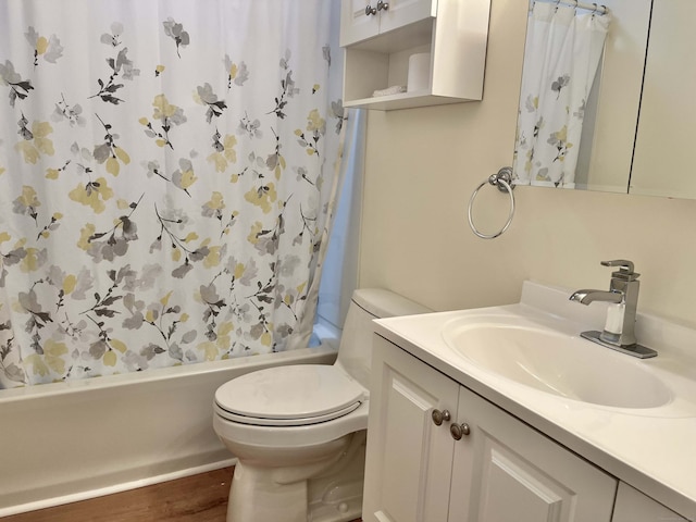 full bathroom with toilet, wood-type flooring, vanity, and shower / tub combo with curtain