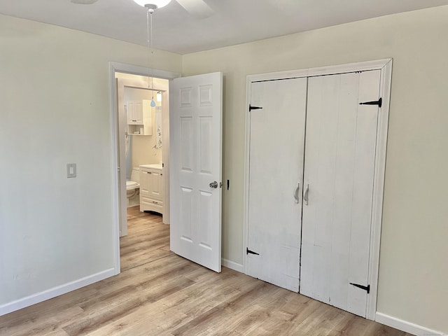 unfurnished bedroom featuring ceiling fan, a closet, and light hardwood / wood-style flooring