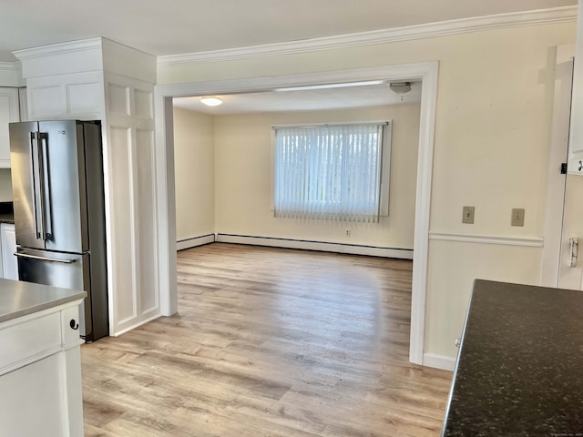 interior space featuring white cabinetry, a baseboard heating unit, ornamental molding, light hardwood / wood-style flooring, and high end refrigerator