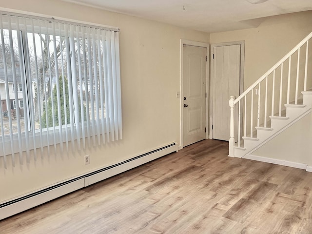 entryway featuring a baseboard heating unit and wood-type flooring