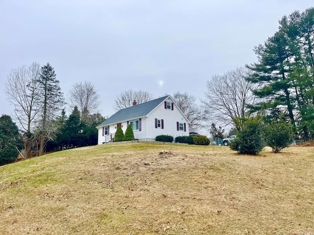 view of side of home with a lawn