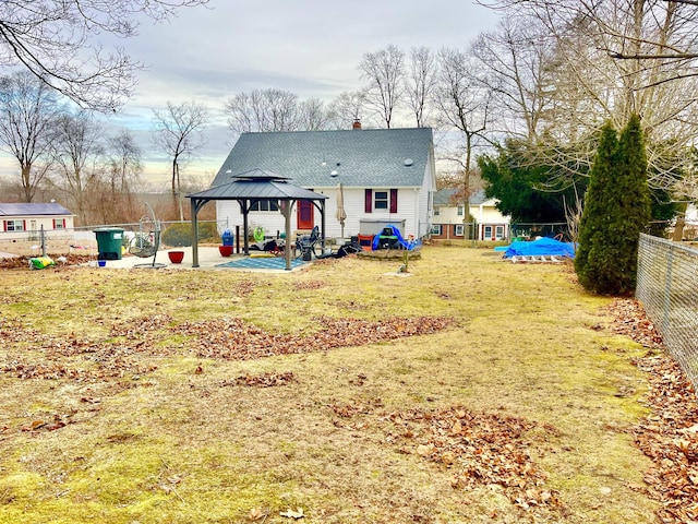 rear view of house with a patio area, a gazebo, and a yard