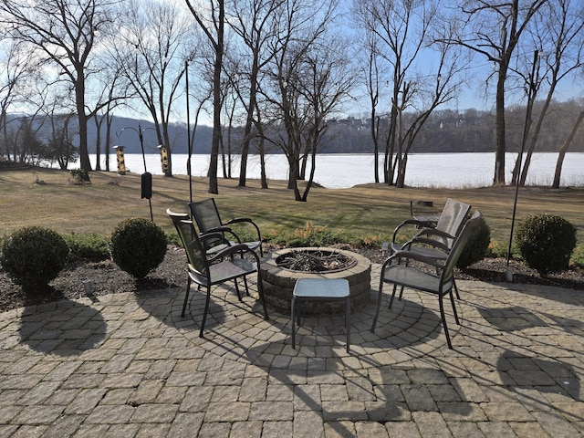 view of patio / terrace with a water view and an outdoor fire pit