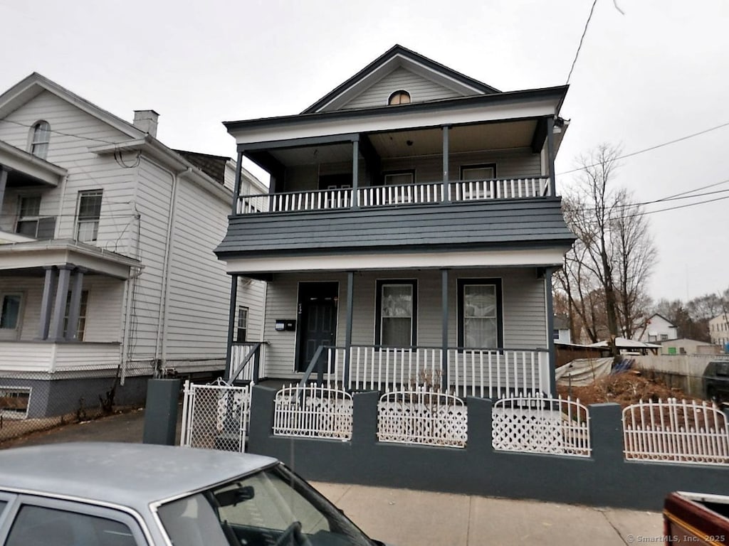 view of front of house with a porch and a balcony