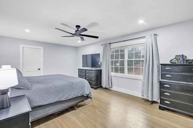 bedroom with ceiling fan and light hardwood / wood-style flooring