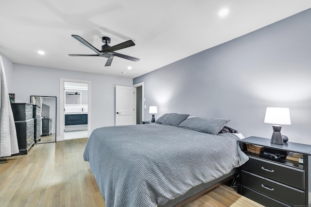 bedroom with connected bathroom, ceiling fan, and light hardwood / wood-style flooring