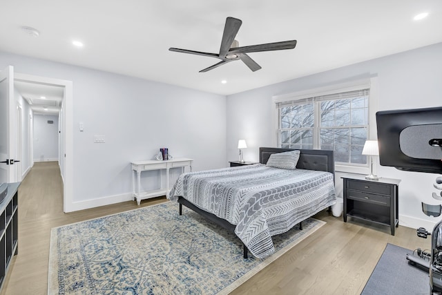 bedroom with ceiling fan and light hardwood / wood-style floors