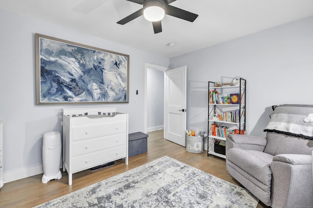 living area featuring ceiling fan and light hardwood / wood-style flooring