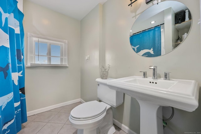 bathroom with tile patterned floors, toilet, and sink