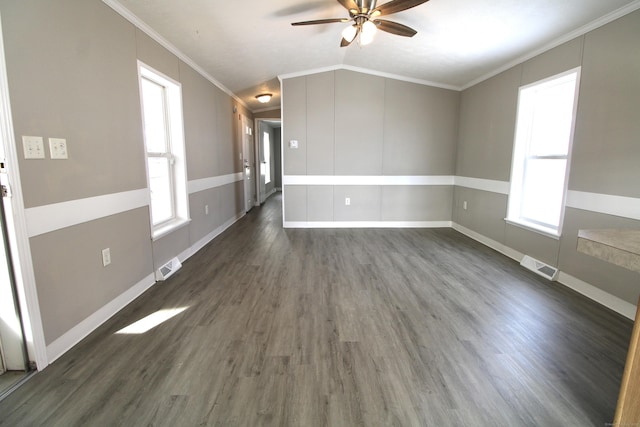 unfurnished room featuring ceiling fan, dark hardwood / wood-style floors, a wealth of natural light, and ornamental molding