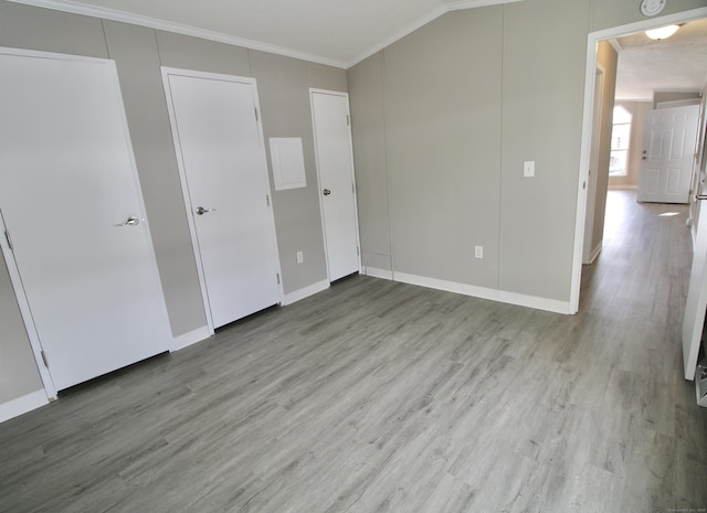 unfurnished bedroom featuring light wood-type flooring and ornamental molding