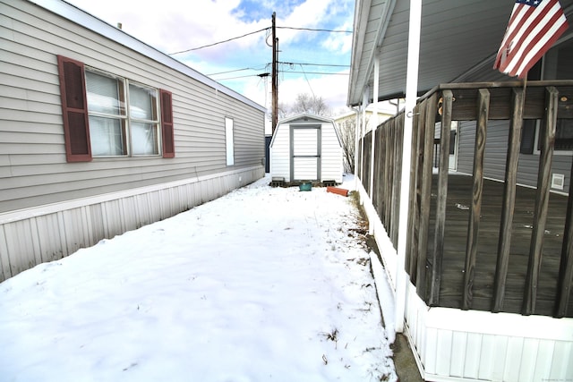 yard layered in snow with a shed