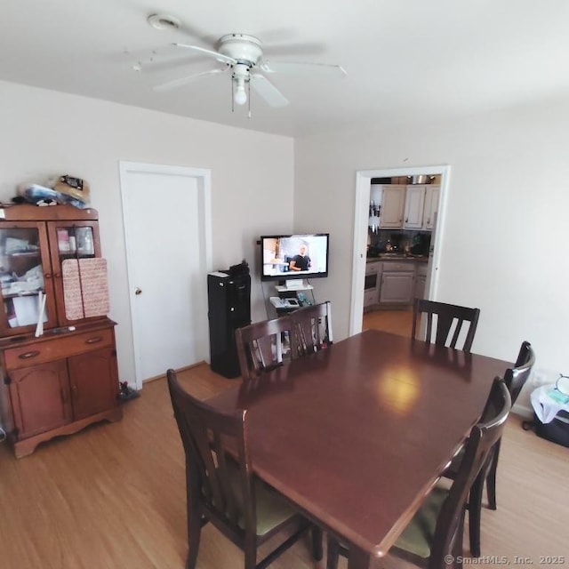 dining room featuring ceiling fan and light hardwood / wood-style flooring