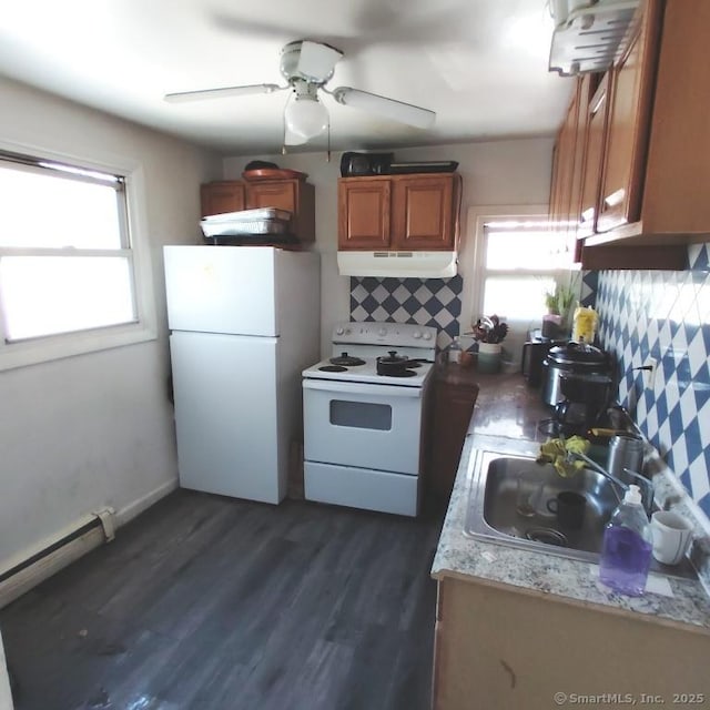 kitchen featuring decorative backsplash, sink, white appliances, and plenty of natural light