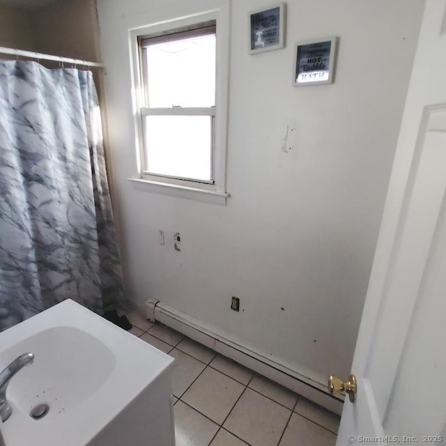 bathroom with tile patterned floors and a baseboard radiator