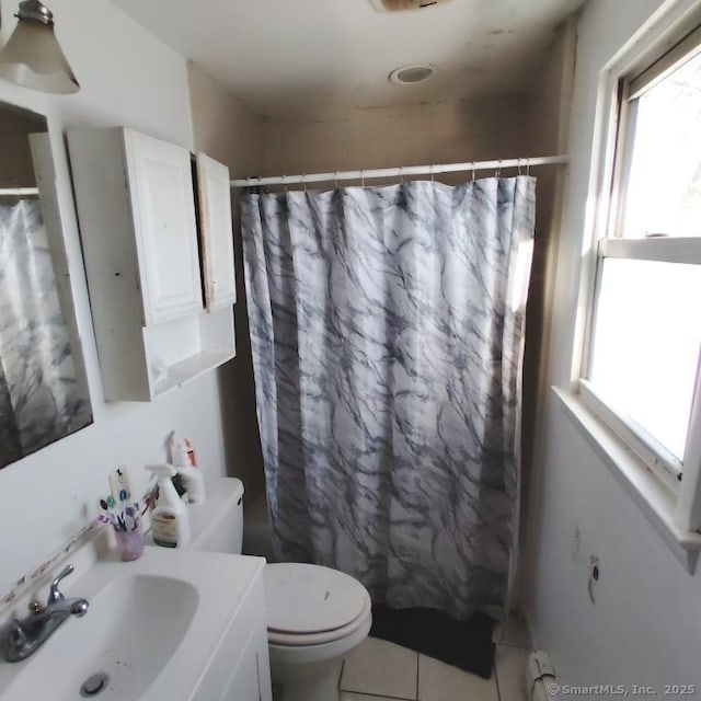 bathroom with vanity, toilet, a shower with curtain, and tile patterned flooring