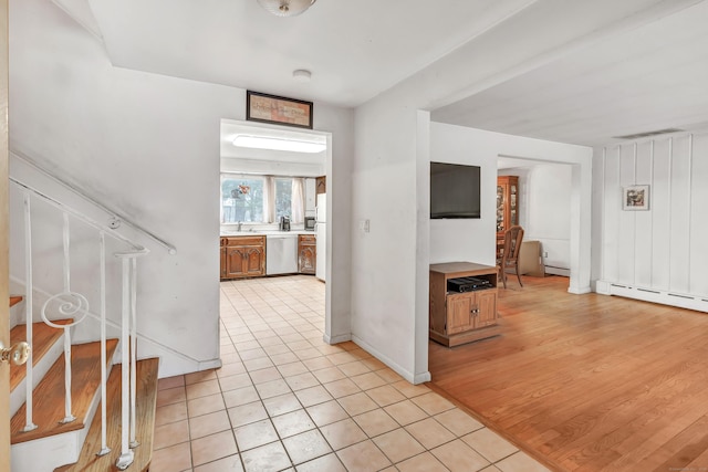 interior space with light tile patterned floors and baseboard heating