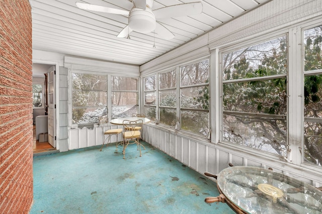 unfurnished sunroom with ceiling fan