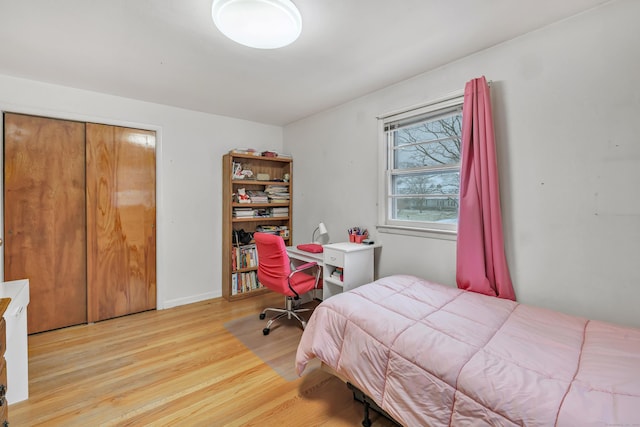 bedroom featuring light hardwood / wood-style flooring and a closet