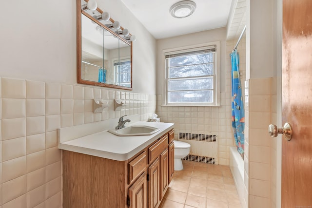 full bathroom with toilet, tile walls, tile patterned floors, radiator, and vanity