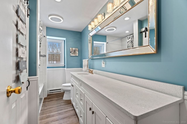 full bathroom with baseboard heating, shower / tub combo, vanity, wood-type flooring, and toilet