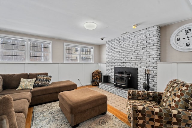 living room featuring wood-type flooring and a wood stove